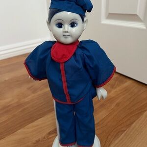 Blue and Red 12” Doll with Accessories. Includes stand.